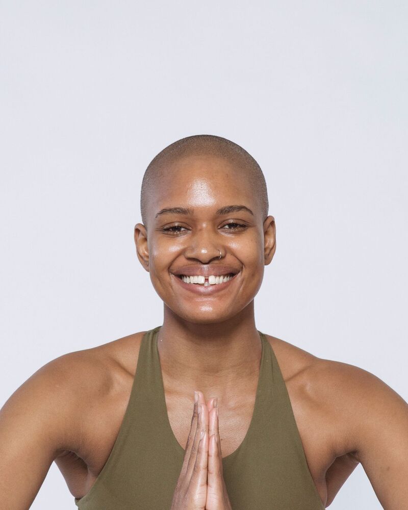 Imani Brooks smiling with her hands together at her heart